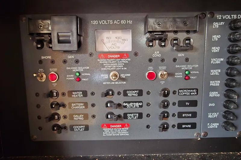 Slide: The Image of Electrical control panel of a 2006 Chaparral Signature 310 boat, featuring various switches and indicators. - 29