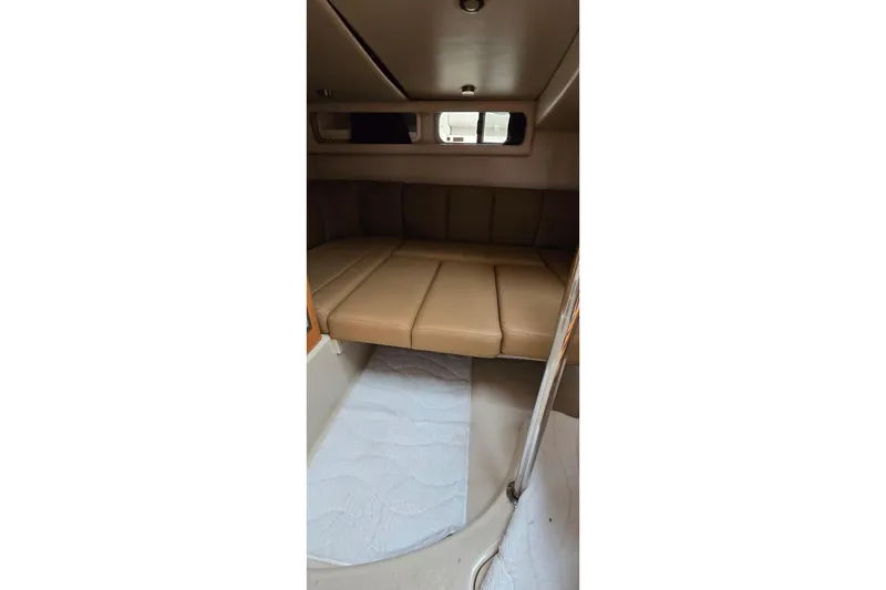 Slide: The Image of 2006 Chaparral Signature 310 cabin interior with beige seating and compact design. - 31