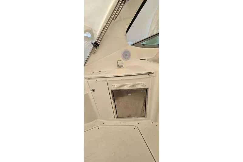 Slide: The Image of 2006 Chaparral Signature 310 boat interior with built-in speaker and storage compartment. - 7