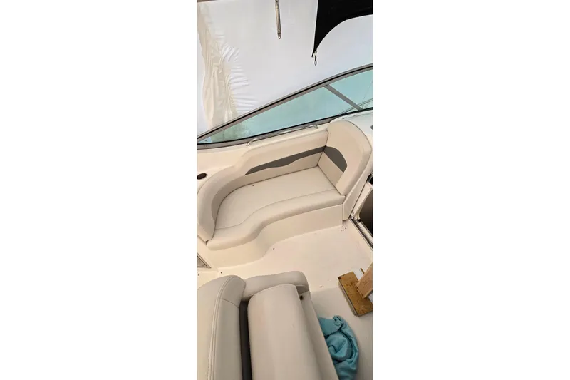 Slide: The Image of Interior seating of 2006 Chaparral Signature 310 boat, featuring beige upholstery. - 8
