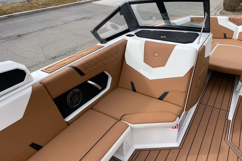 Slide: The Image of 2026 Nautique Super Air Nautique GS24 interior with tan and white seating, modern design. - 10