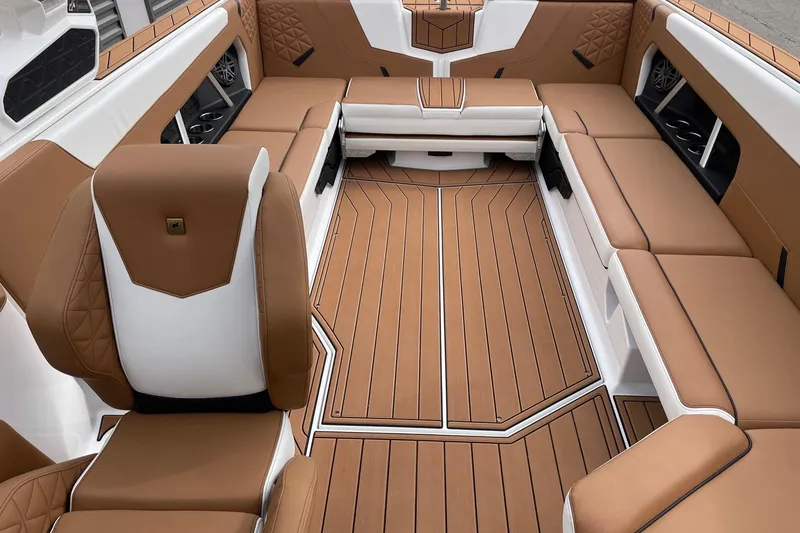 Slide: The Image of 2026 Nautique Super Air Nautique GS24 interior with luxurious brown and white seating. - 12