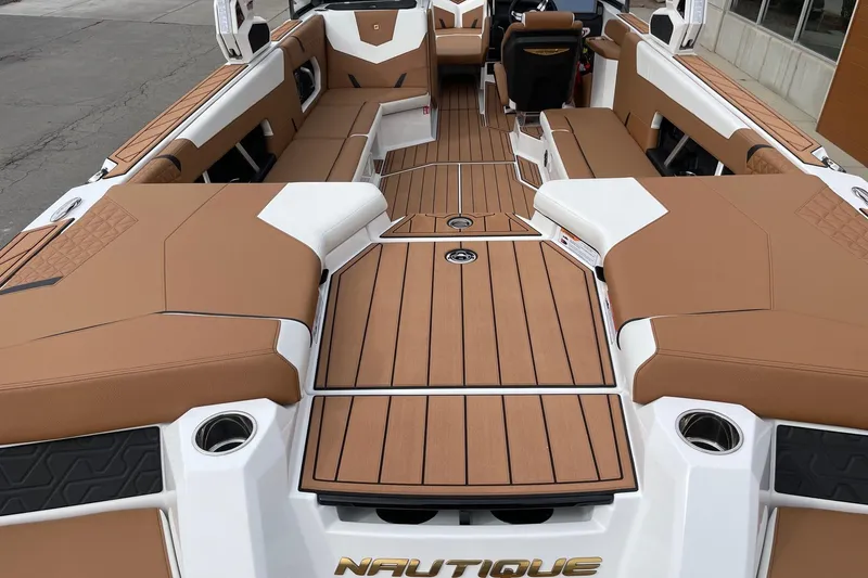 Slide: The Image of 2026 Nautique Super Air Nautique GS24 interior with tan upholstery and sleek design. - 4