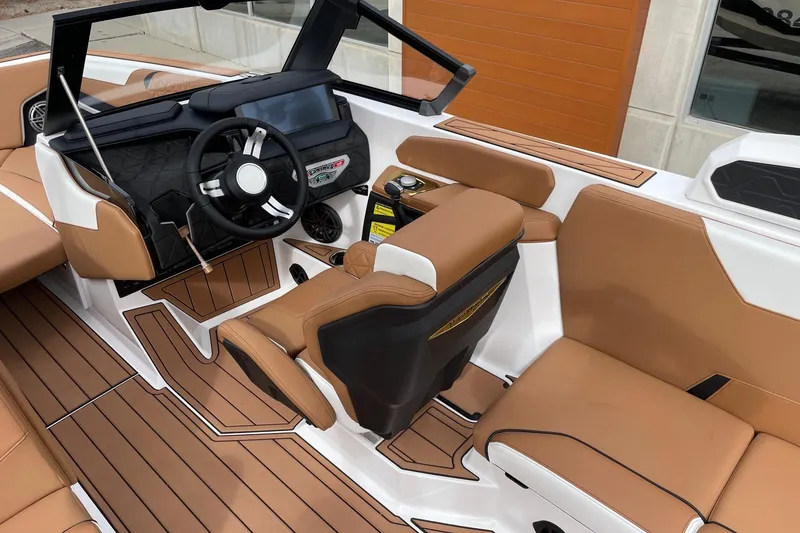 Slide: The Image of 2026 Nautique Super Air Nautique GS24 interior with tan seating and modern dashboard. - 6