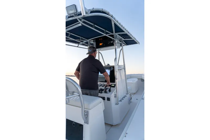 Slide: The Image of Man steering 2005 Contender 27 Tournament boat under blue canopy. - 14