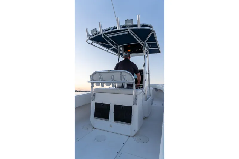 Slide: The Image of 2005 Contender 27 Tournament boat with T-top, viewed from the rear at sunset. - 15
