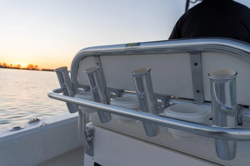 Slide: The Image of 2005 Contender 27 Tournament boat rod holders at sunset on calm water. - 16