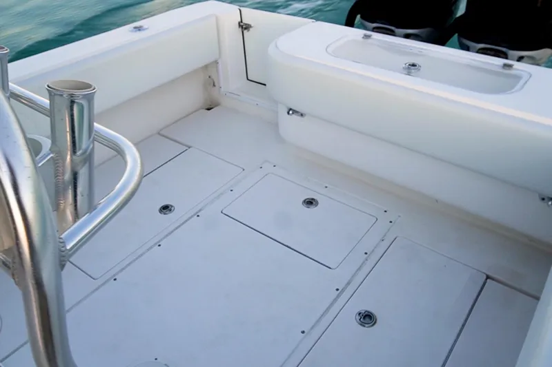 Slide: The Image of 2005 Contender 27 Tournament boat deck with storage compartments and rod holders. - 17
