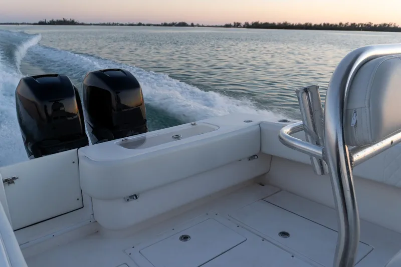 Slide: The Image of 2005 Contender 27 Tournament boat cruising on calm waters at sunset. - 18