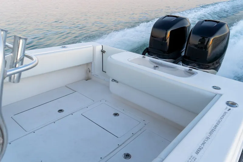 Slide: The Image of 2005 Contender 27 Tournament boat with dual outboard engines on calm water. - 19