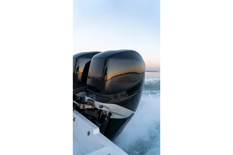 Slide: The Image of Twin outboard motors on a 2005 Contender 27 Tournament boat at sunset. - 20
