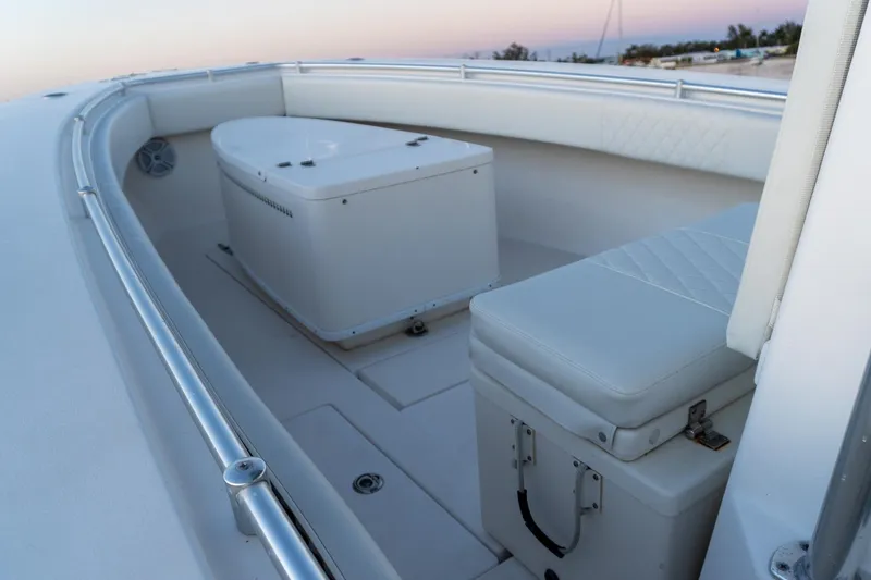 Slide: The Image of 2005 Contender 27 Tournament boat interior with cushioned seating and storage compartments. - 23