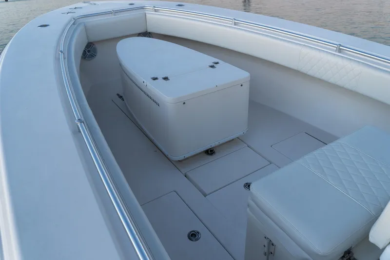 Slide: The Image of 2005 Contender 27 Tournament boat interior with seating and storage, on calm water. - 24