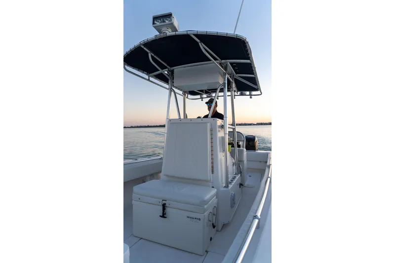 Slide: The Image of 2005 Contender 27 Tournament boat on water at sunset, featuring T-top and seating. - 27