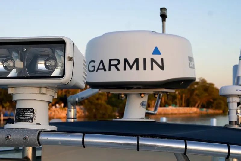 Slide: The Image of 2005 Contender 27 Tournament boat with Garmin radar and spotlight, docked at sunset. - 28