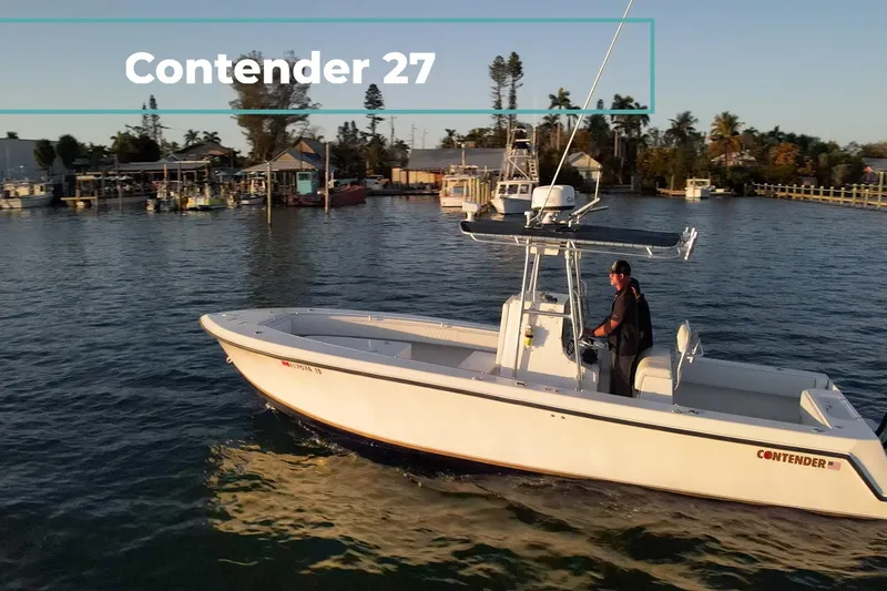 Slide: The Image of 2005 Contender 27 Tournament boat cruising on calm waters near a marina. - 3