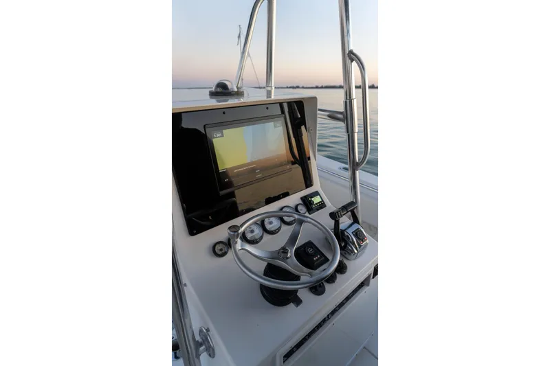 Slide: The Image of 2005 Contender 27 Tournament boat helm with steering wheel and navigation display. - 32
