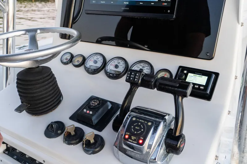 Slide: The Image of Dashboard of a 2005 Contender 27 Tournament boat with steering wheel and gauges. - 35