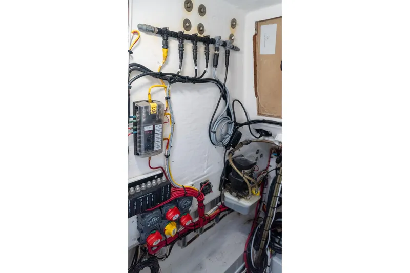Slide: The Image of Electrical system inside a 2005 Contender 27 Tournament boat, featuring wiring and components. - 36