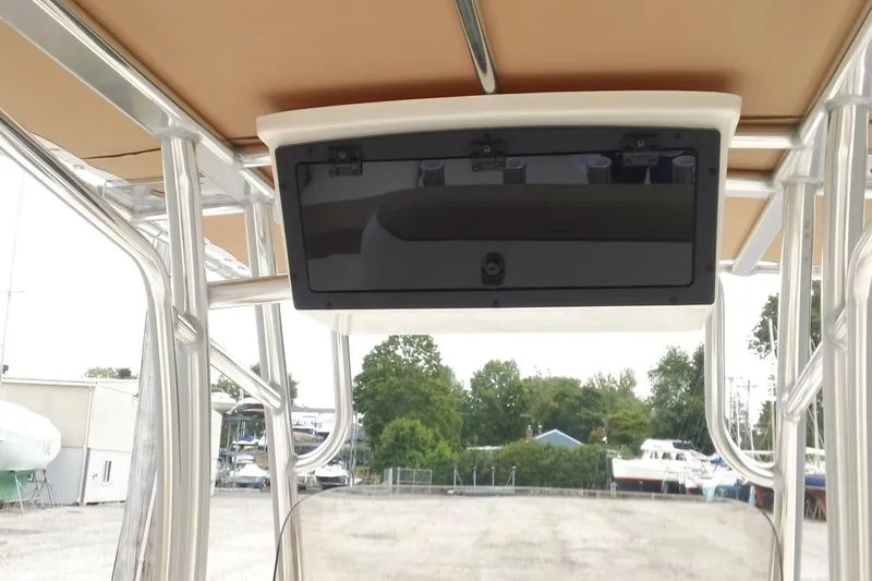 Slide: The Image of 2026 Pioneer 202 Islander boat console with storage compartment, docked outdoors. - 5