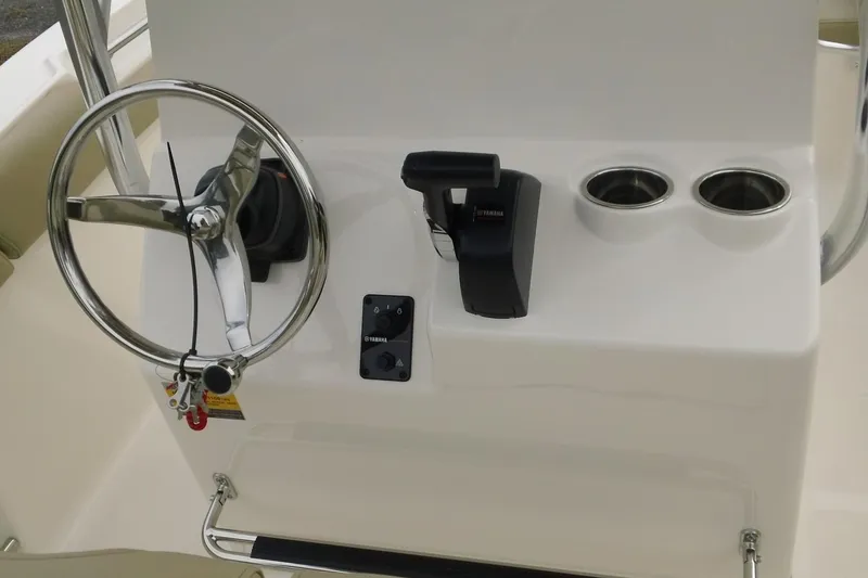 Slide: The Image of 2026 Pioneer 202 Islander boat console with steering wheel and controls. - 6