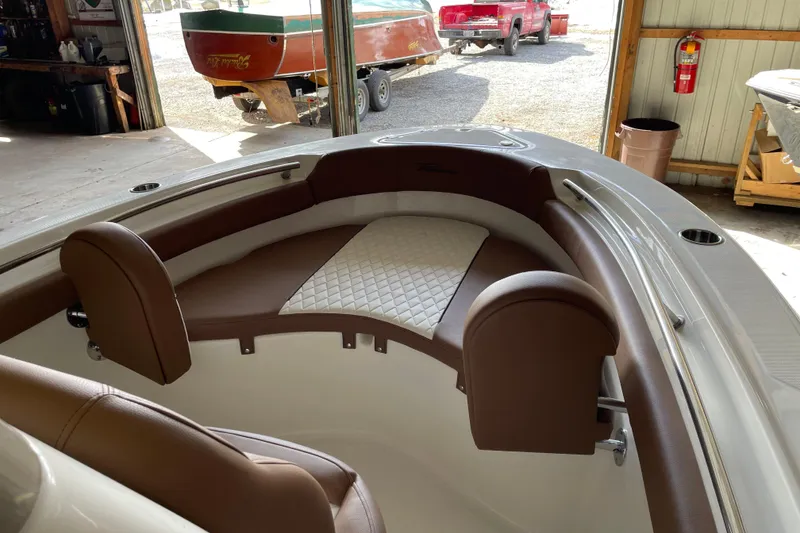 Slide: The Image of Interior of 2026 Pioneer 202 Islander boat with brown and white seating. - 9