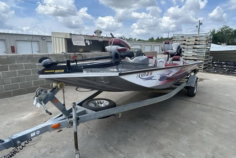 Slide: The Image of 2014 G3 Eagle Talon 19 DLX boat on trailer, parked outdoors under cloudy sky. - 1