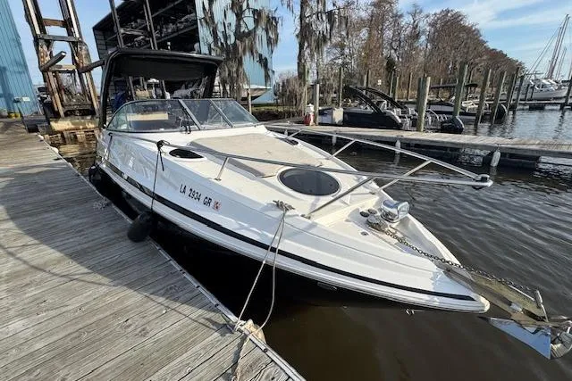 Slide: The Image of 2023 Regal 28 Express boat docked at marina with scenic background. - 10