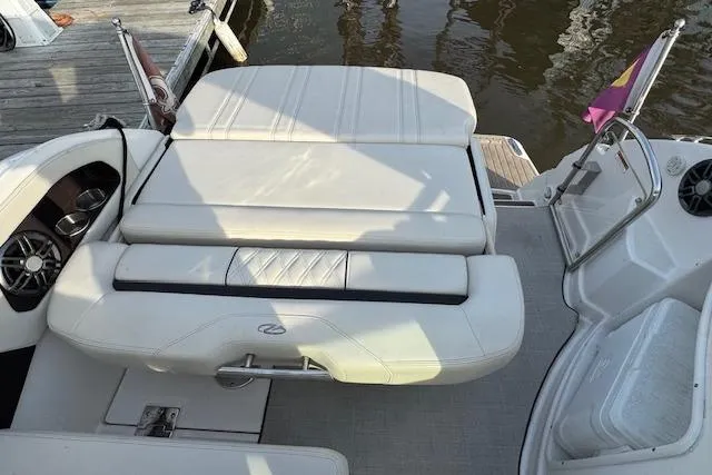 Slide: The Image of 2023 Regal 28 Express boat interior with white seating and dock view. - 11