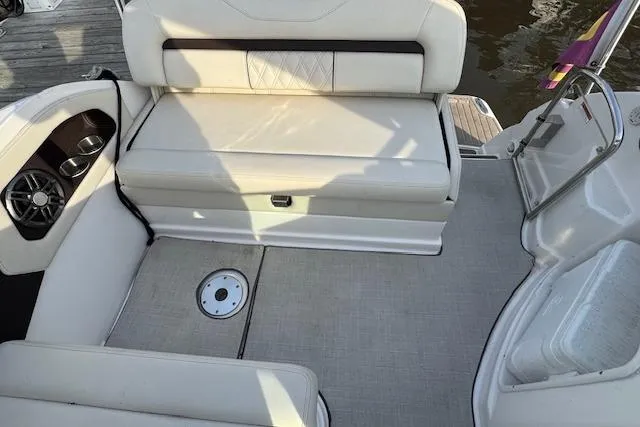 Slide: The Image of 2023 Regal 28 Express boat interior with white seating and speaker system. - 12