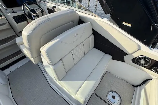Slide: The Image of 2023 Regal 28 Express boat interior with luxurious seating and modern steering wheel. - 13