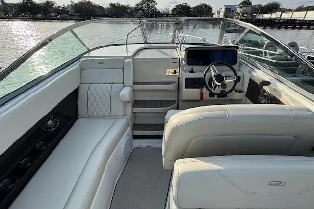 Slide: The Image of 2023 Regal 28 Express boat interior with luxurious seating and modern dashboard. - 16