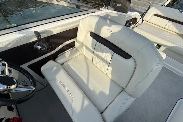 Slide: The Image of 2023 Regal 28 Express boat interior with white leather seating and steering wheel. - 17