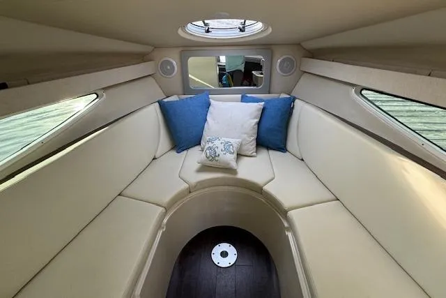 Slide: The Image of Interior of 2023 Regal 28 Express boat with cozy seating and decorative pillows. - 23