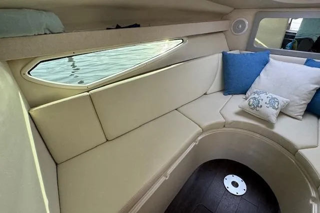 Slide: The Image of 2023 Regal 28 Express cabin interior with beige seating and decorative pillows. - 24