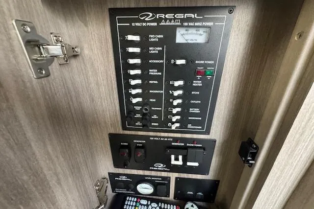 Slide: The Image of Control panel of 2023 Regal 28 Express boat, featuring switches and power indicators. - 28