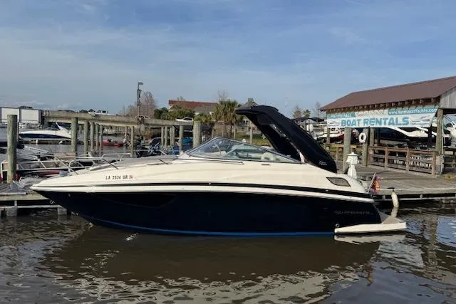 Slide: The Image of 2023 Regal 28 Express boat docked at marina with rental sign in background. - 4