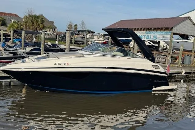 Slide: The Image of 2023 Regal 28 Express boat docked at marina, side view. - 6