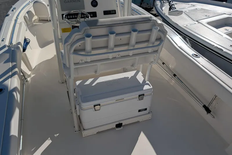 Slide: The Image of 2023 Key West 239 FS boat interior with helm, seating, and cooler storage. - 10