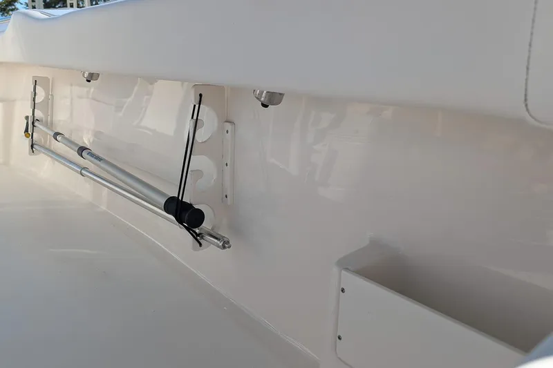 Slide: The Image of 2023 Key West 239 FS boat interior with rod holder and storage compartment. - 12