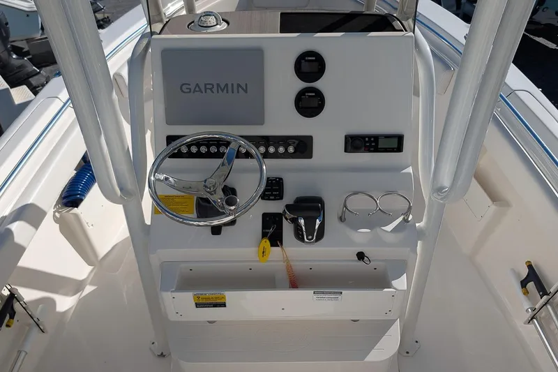 Slide: The Image of 2023 Key West 239 FS boat dashboard with Garmin navigation system and steering wheel. - 14