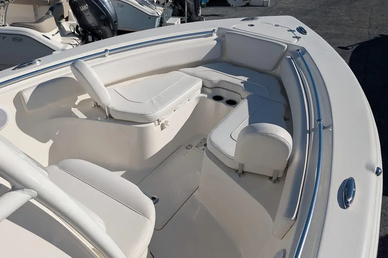 Slide: The Image of 2023 Key West 239 FS boat interior with white seating and cup holders. - 17