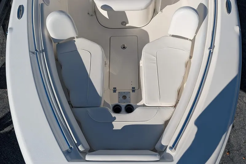 Slide: The Image of 2023 Key West 239 FS boat interior with white seating and cup holders. - 19