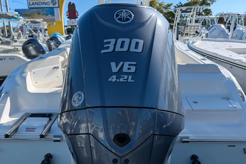 Slide: The Image of 2023 Key West 239 FS boat with Yamaha 300 V6 4.2L engine at a marina. - 5