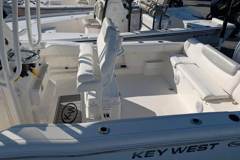 Slide: The Image of 2023 Key West 239 FS boat interior with white seating and steering console. - 6