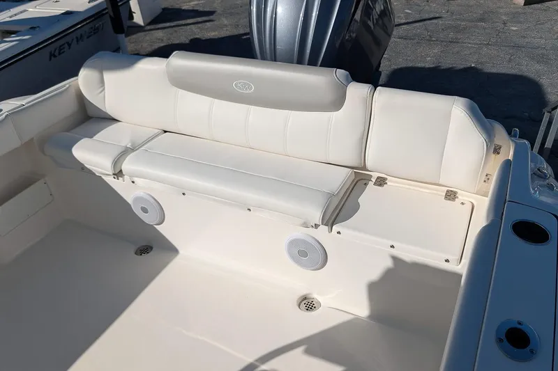 Slide: The Image of 2023 Key West 239 FS boat interior with white seating and built-in speakers. - 8