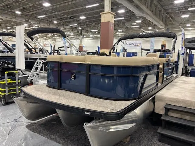 Slide: The Image of 2026 Godfrey EX2286SBX pontoon boat displayed at a trade show. - 2