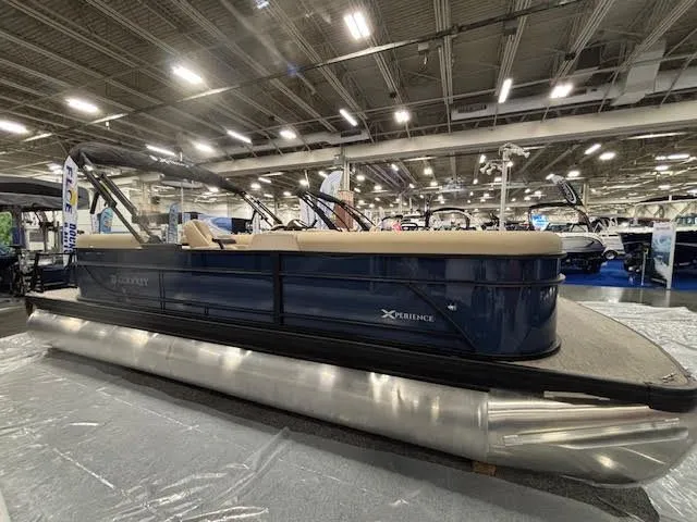 Slide: The Image of Godfrey EX2286SBX 2026 pontoon boat displayed at a show. - 3