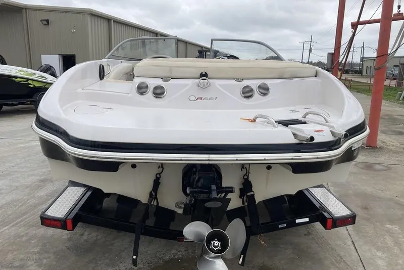Slide: The Image of 2012 Tahoe Q8 SSi boat rear view, parked on a trailer in a marina. - 4