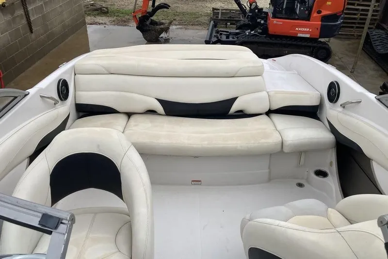 Slide: The Image of 2012 Tahoe Q8 SSi boat interior with white and black seating, outdoor setting. - 5